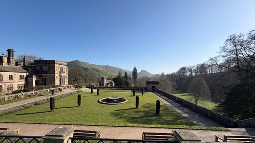 A view over Italian gardens with a flat topped cloud in the background